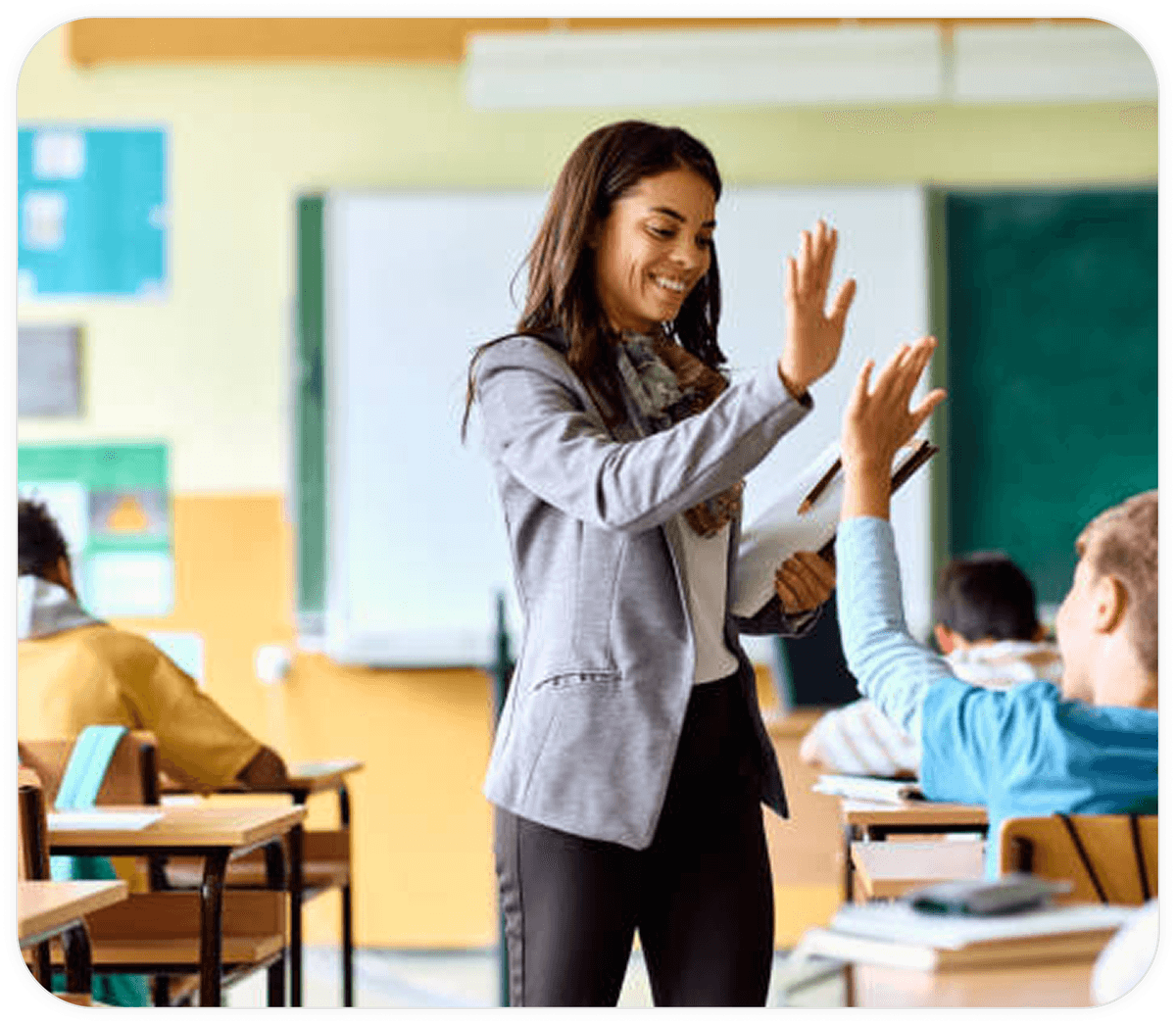 Teacher woman teaches two students in a classroom
